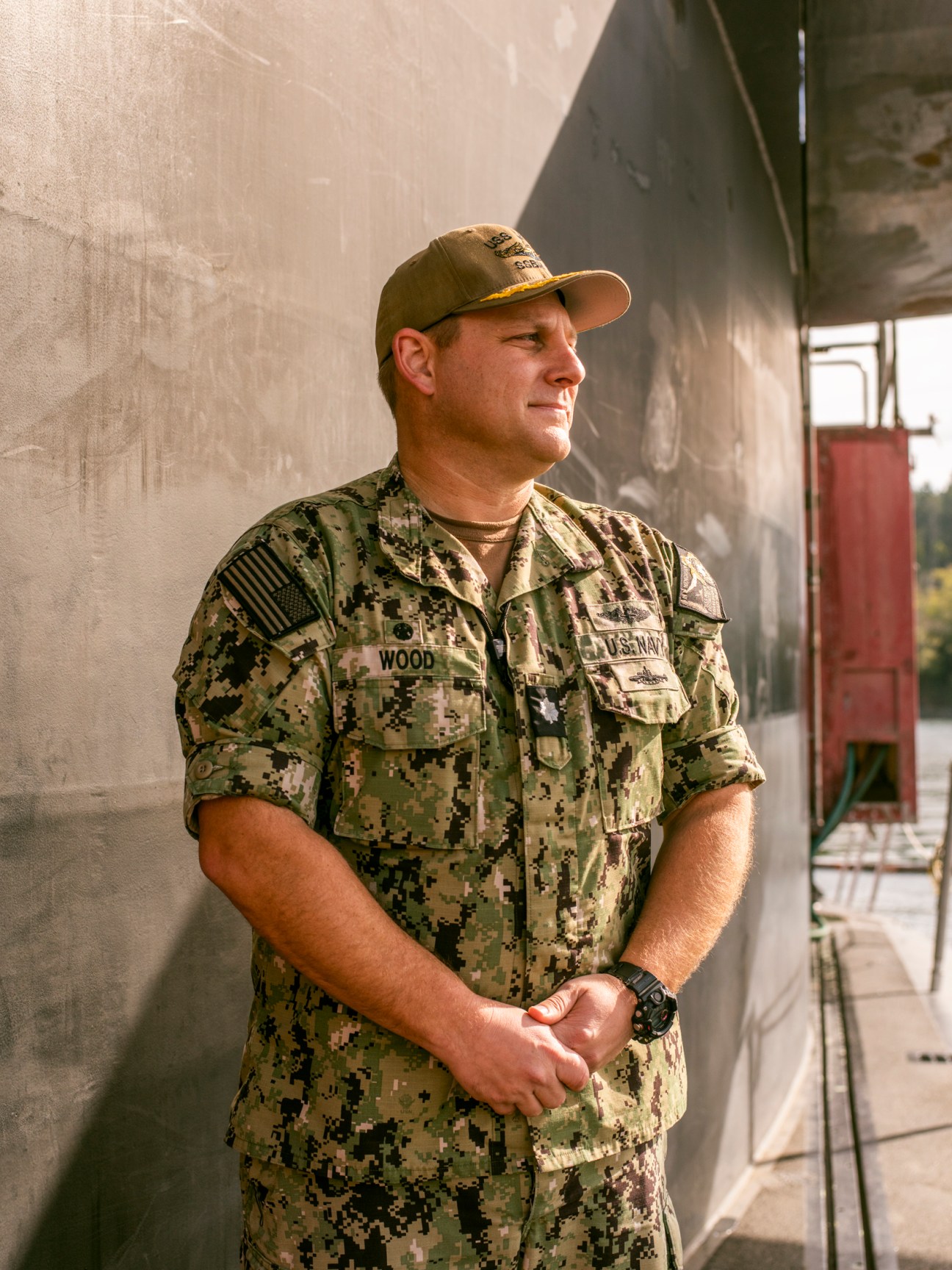USS Maine Commanding Officer Travis Wood in naval camouflage uniform at a naval facility