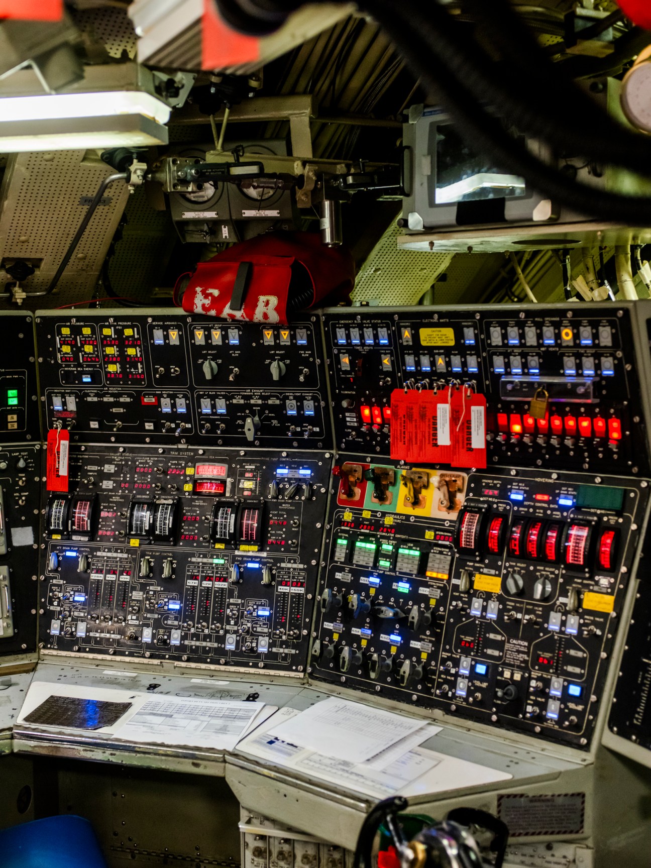 Nuclear submarine control centre with illuminated panels, switches, and monitoring displays.