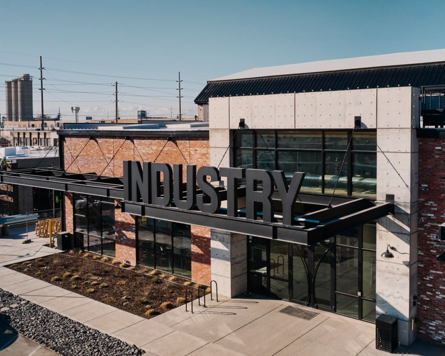 Modern industrial building with large INDUSTRY sign on steel framework structure