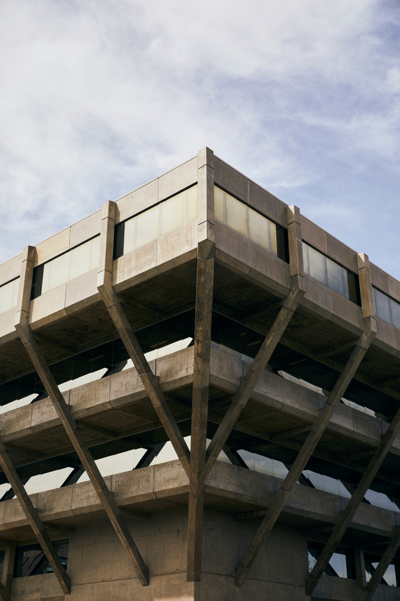 Brutalist concrete parking structure with angular geometric forms and large window openings.