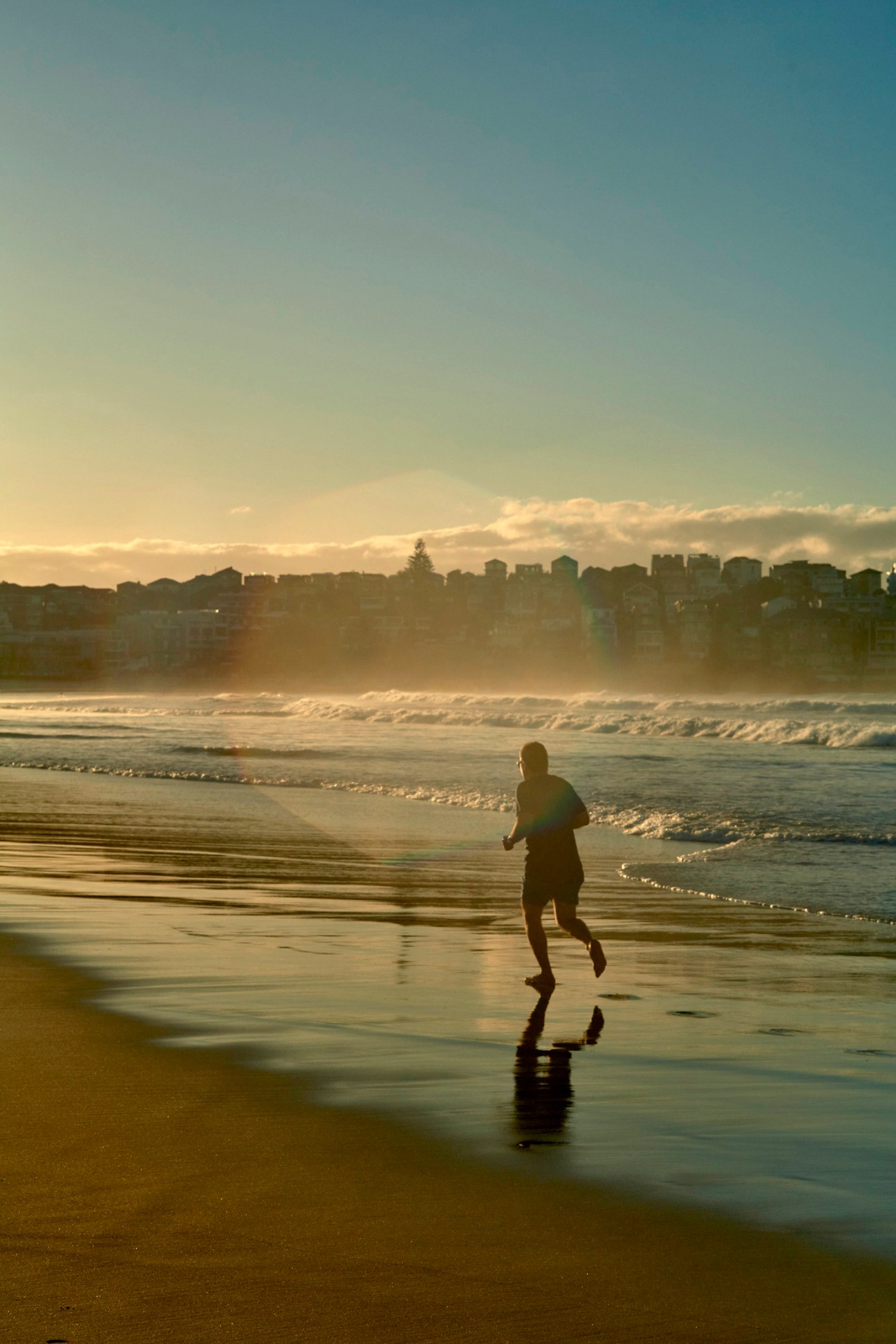 Person running along Sydney waterfront demonstrating healthy knee movement and exercise