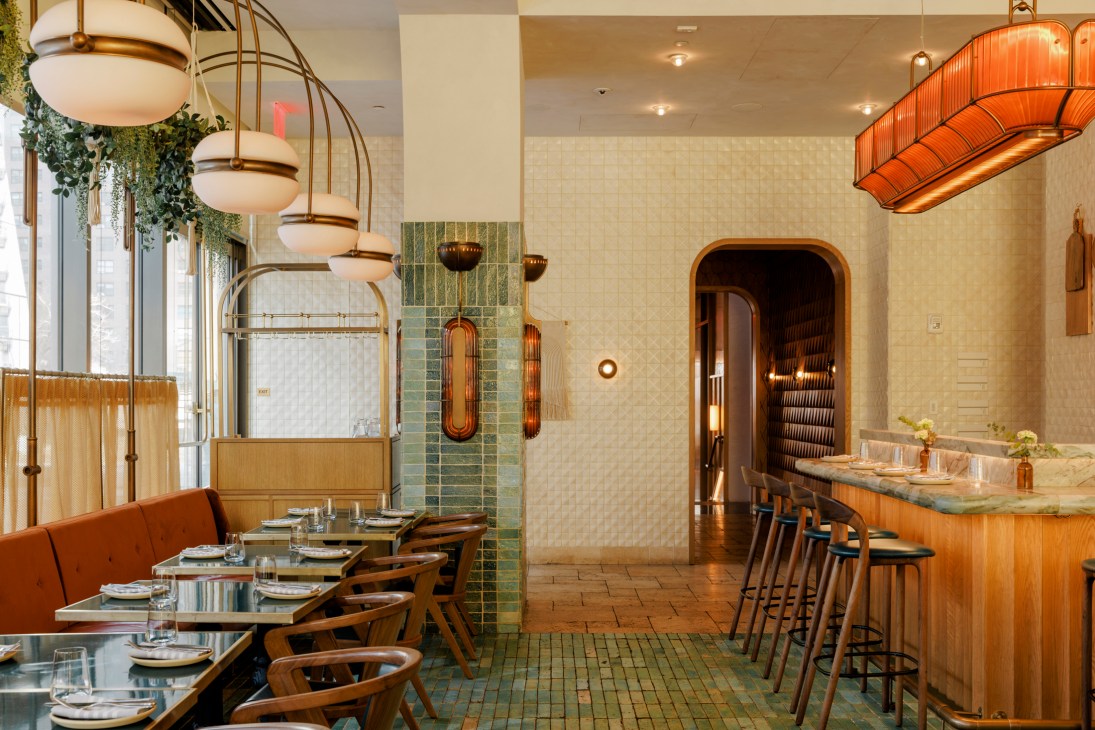 Modern restaurant interior with warm lighting, bar seating, and archway entrance at Zou Zou's