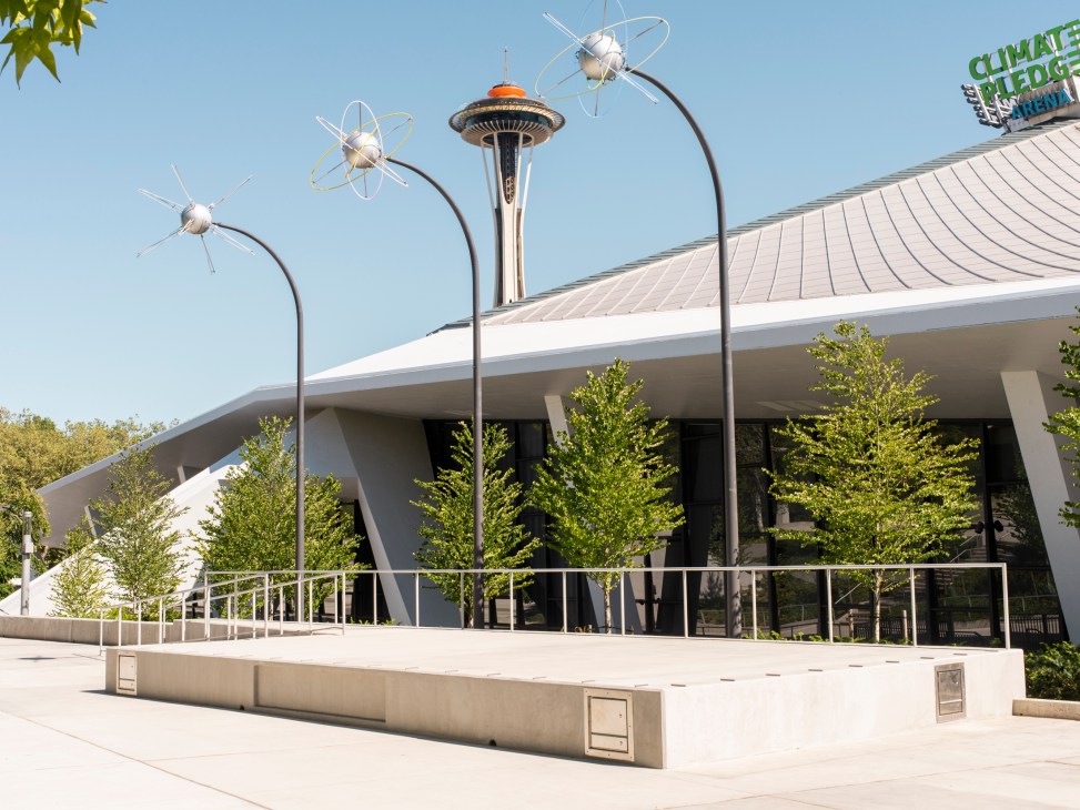 Modern outdoor performance stage with curved seating area and lighting equipment at KEXP radio station