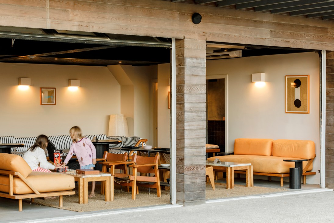 Outdoor seating area with orange leather furniture and exposed wooden beams at Marram Hotel