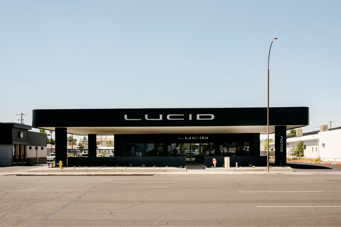 Modern black Lucid Motors showroom with large glass windows displaying luxury electric vehicles