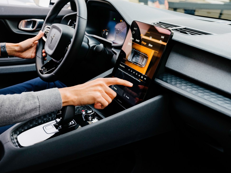 Modern car interior showing digital dashboard display, steering wheel, and center console with touchscreen