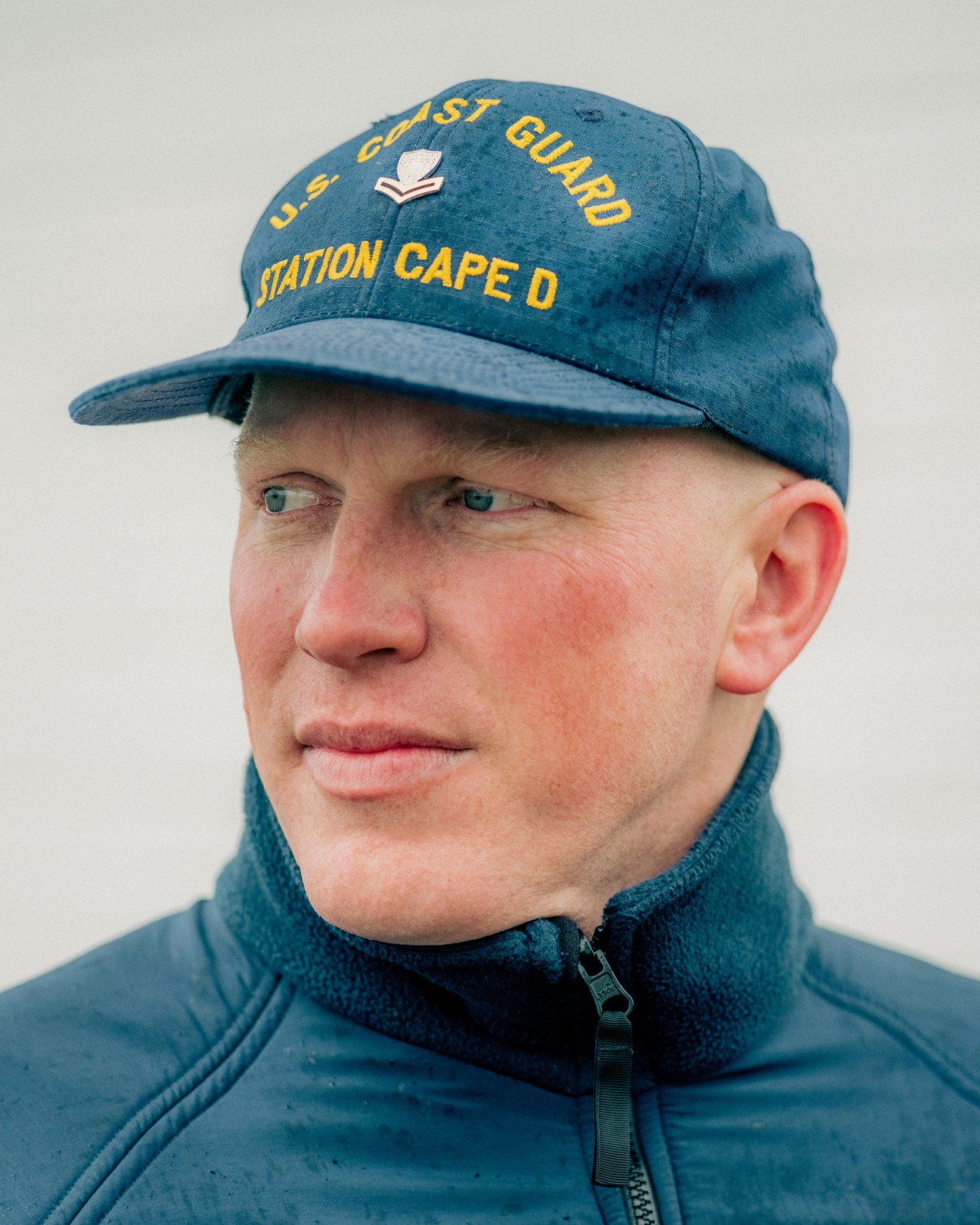 Portrait of Boatswain's Mate Second Class Derek Samuelson in US Coast Guard uniform and cap