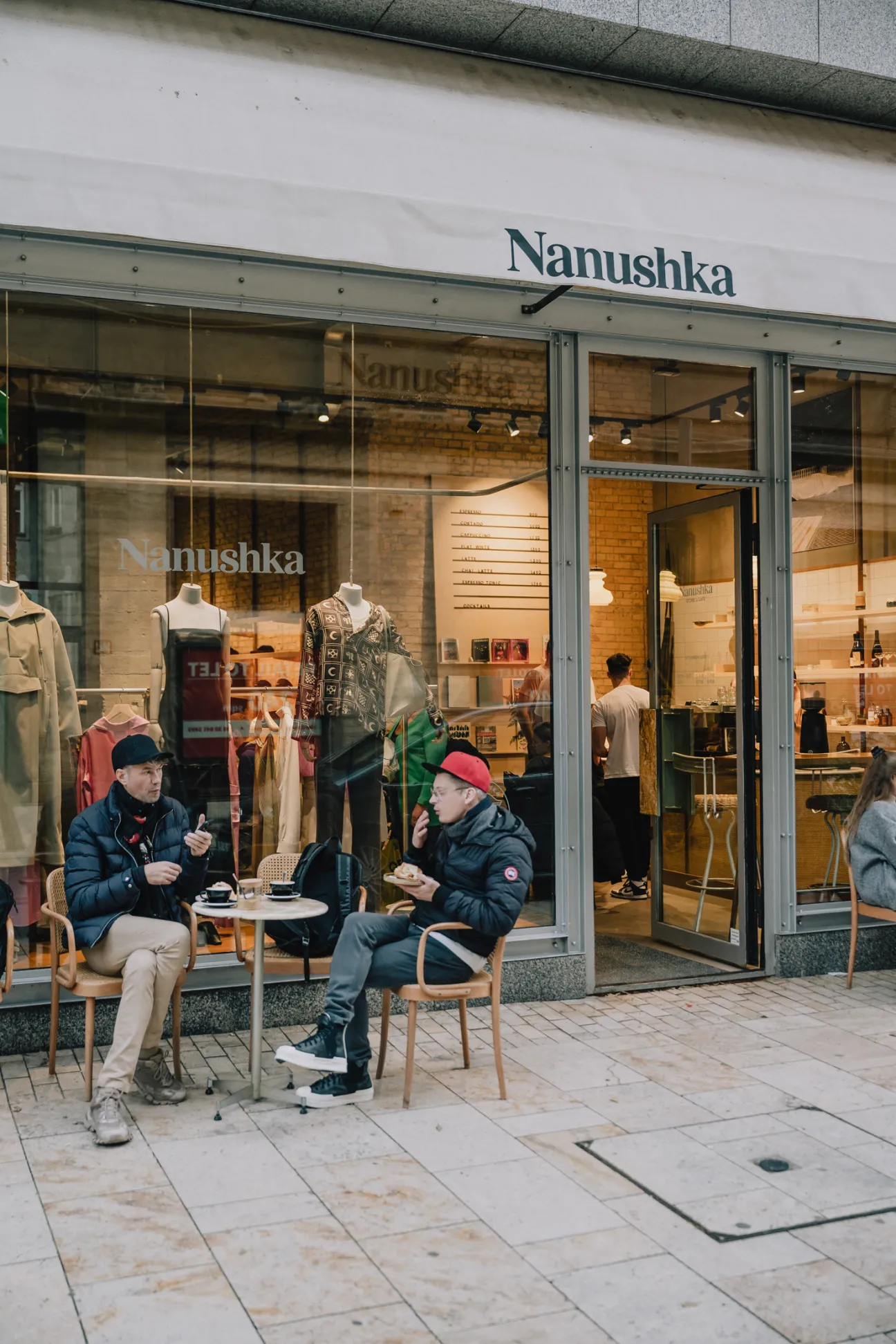 Display of Nanushka men's and women's collections with long forms and modern designs