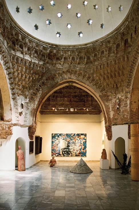 Interior view of the National Gallery of Macedonia showing exhibition space with artwork displayed on white walls