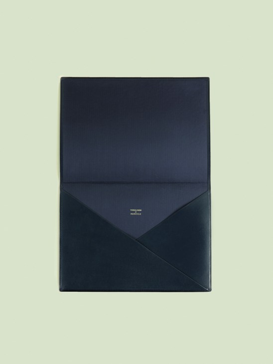 Treuleben × Monocle navy leather envelope folio with flap closure.