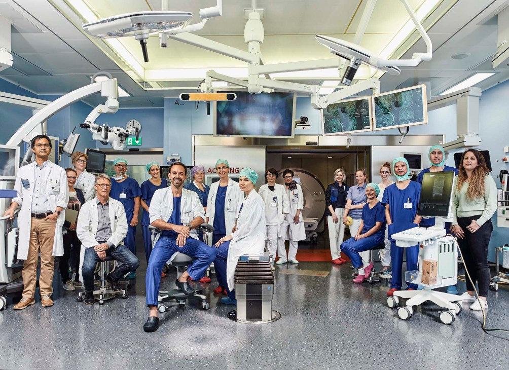 Neurosurgical oncology team at University Hospital of Bern posing together in an operating room