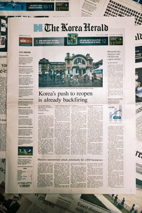 Front page of The Korea Herald newspaper showing headline 'Korea's push to reopen is already backfiring'
