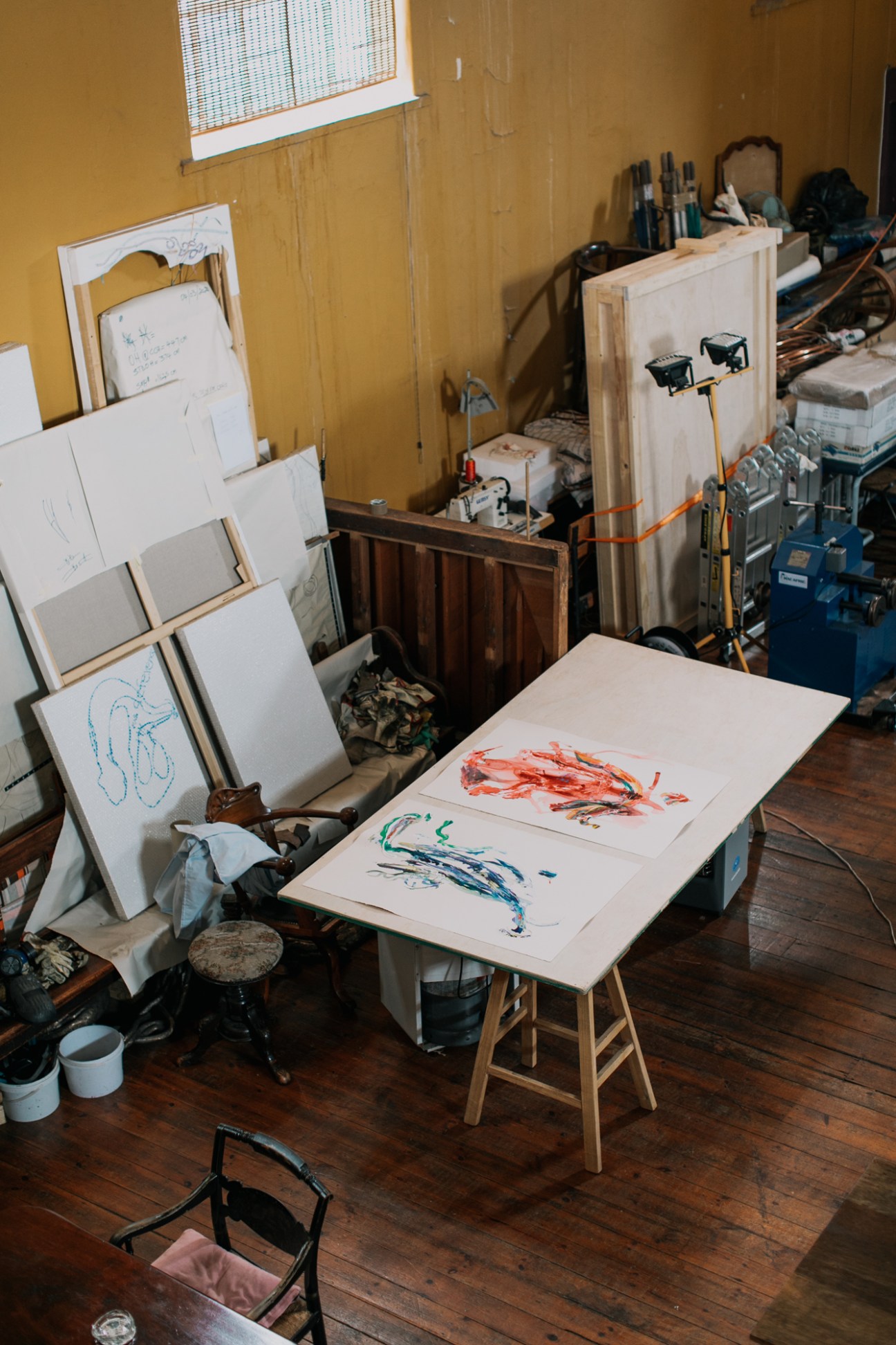 Nicholas Hlobo's art studio workspace in a converted old synagogue with easel, paintings, and art supplies