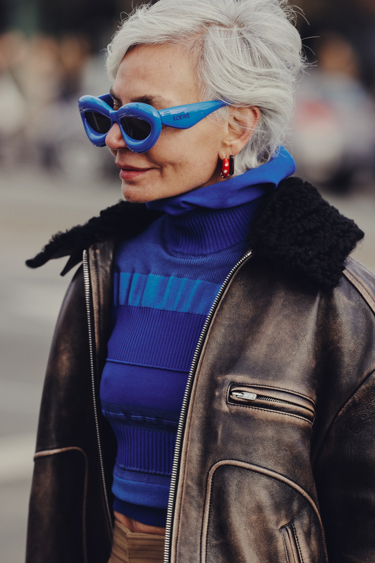 Fashion week attendee in contemporary menswear including oversized jacket and sneakers on Copenhagen street
