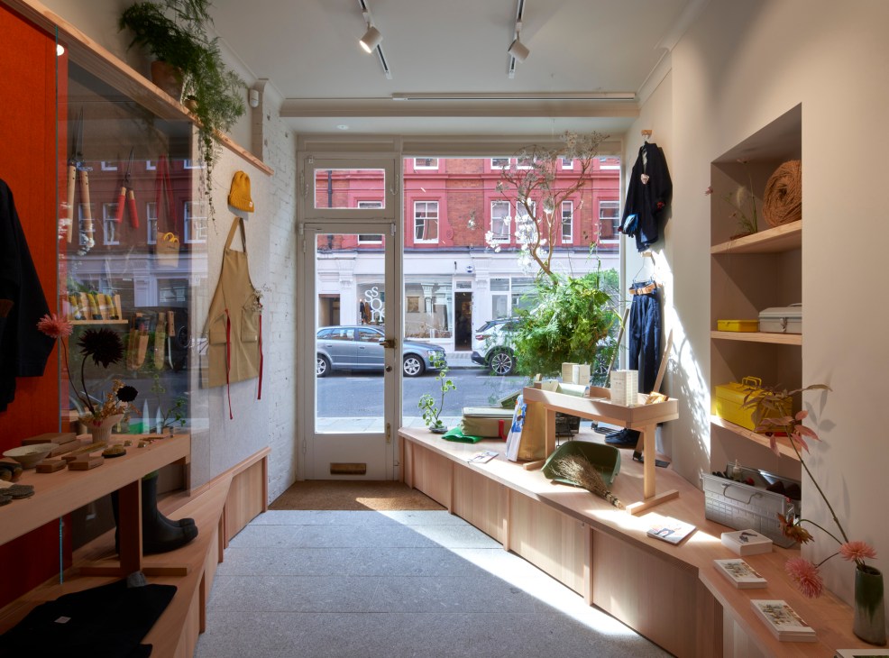 Interior of Niwaki shop showing wooden shelving displaying Japanese gardening tools and clean modern fitout