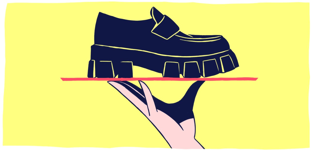 Illustration of a hand holding a dark blue chunky-soled loafer shoe on a bright yellow background.