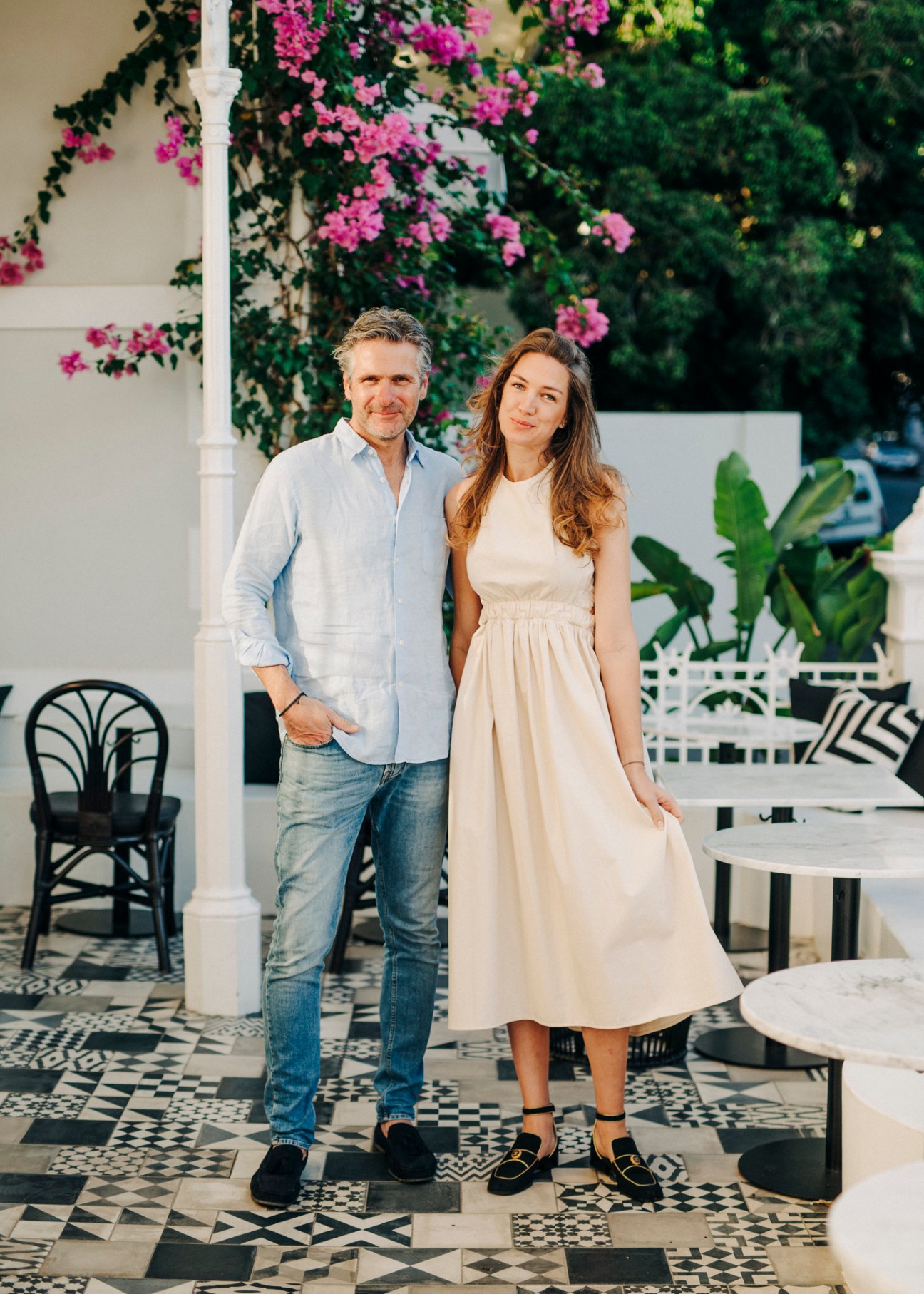 Couple standing together on geometric tiled terrace at Noah House hotel in Cape Town