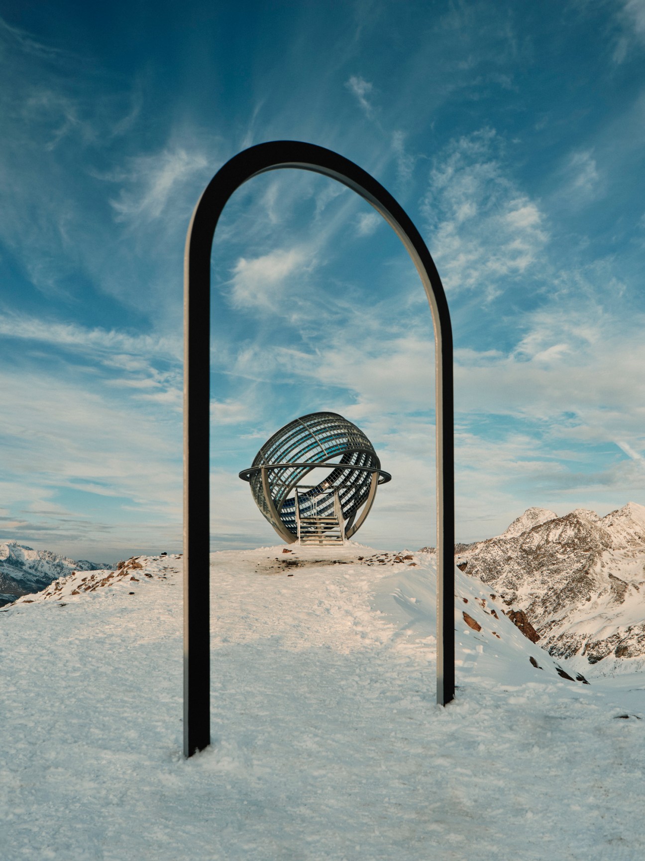 Olafur Eliasson's 'Our Glacial Perspectives' globe sculpture on an Alpine glacier with snowy peaks in background.
