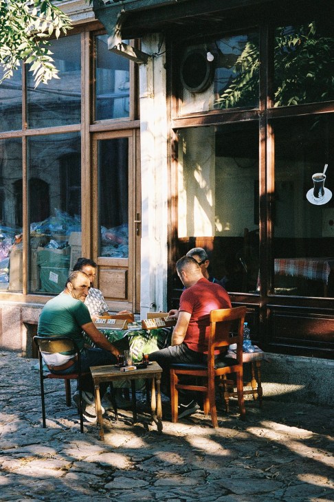 People walking through the cobblestone streets of Skopje's Old Bazaar
