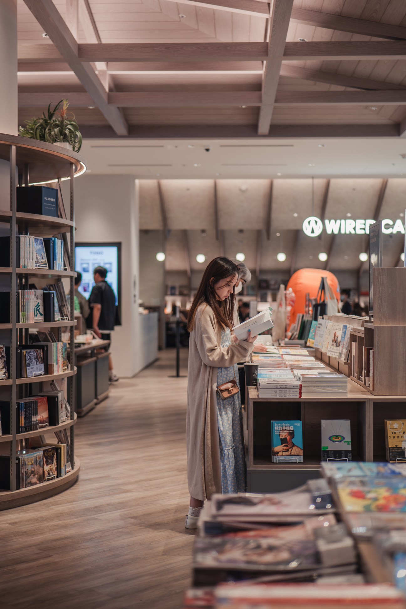 Woman browsing books at Tsutaya bookshop inside Noke mall in Taipei.