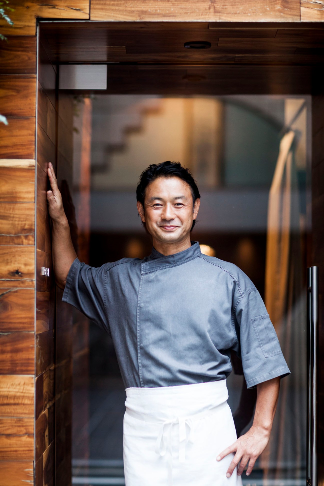 Tetsuya Honda, owner-chef of Ristorante Honda, standing in doorway wearing chef's coat and apron