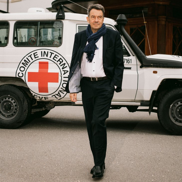 Peter Maurer standing beside an International Committee of the Red Cross vehicle