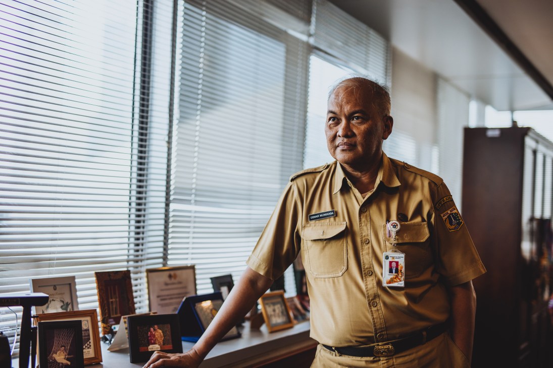 Oswar Mungkasa, Jakarta's deputy governor for spatial planning and environment, stands in an office wearing a tan uniform shirt.