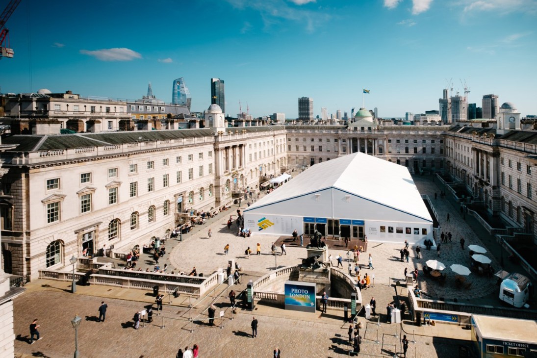 Aerial view of Photo London fair pavilion at Somerset House with visitors browsing photography displays