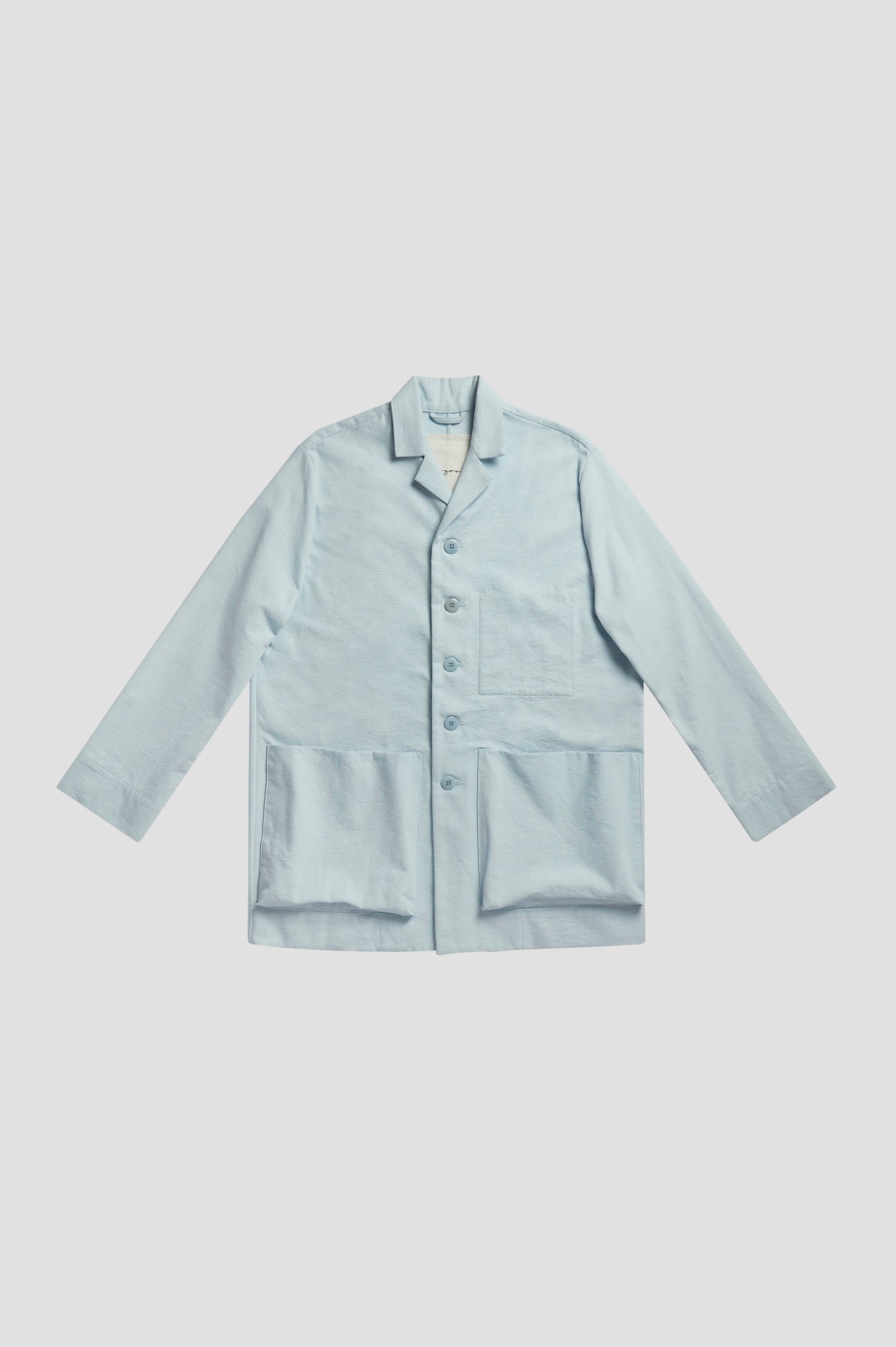Toogood Photographer jacket in powder-blue canvas with button front and chest pocket.