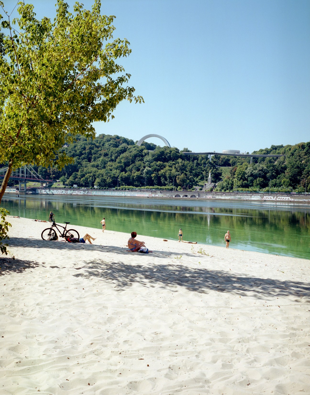 People enjoying leisure time along the banks of the Dnipro river