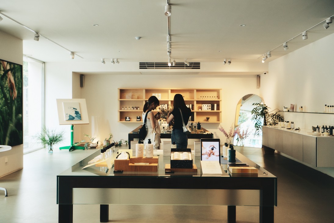 Minimalist retail interior with wooden shelving, white walls, and clean modern design at Nonfiction fragrance store