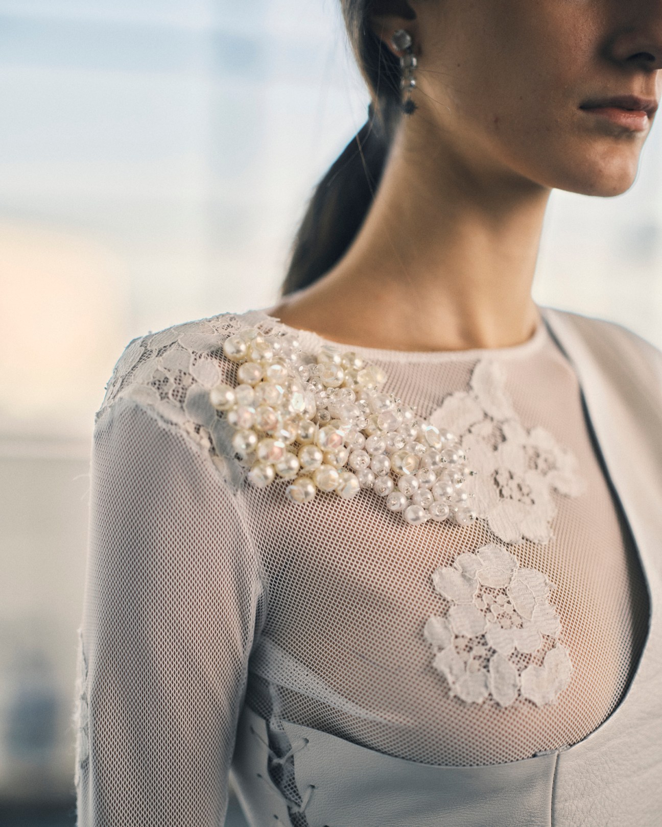 Contemporary dress design by student Bruna Giordano featuring white lace, pearls and sheer mesh detailing