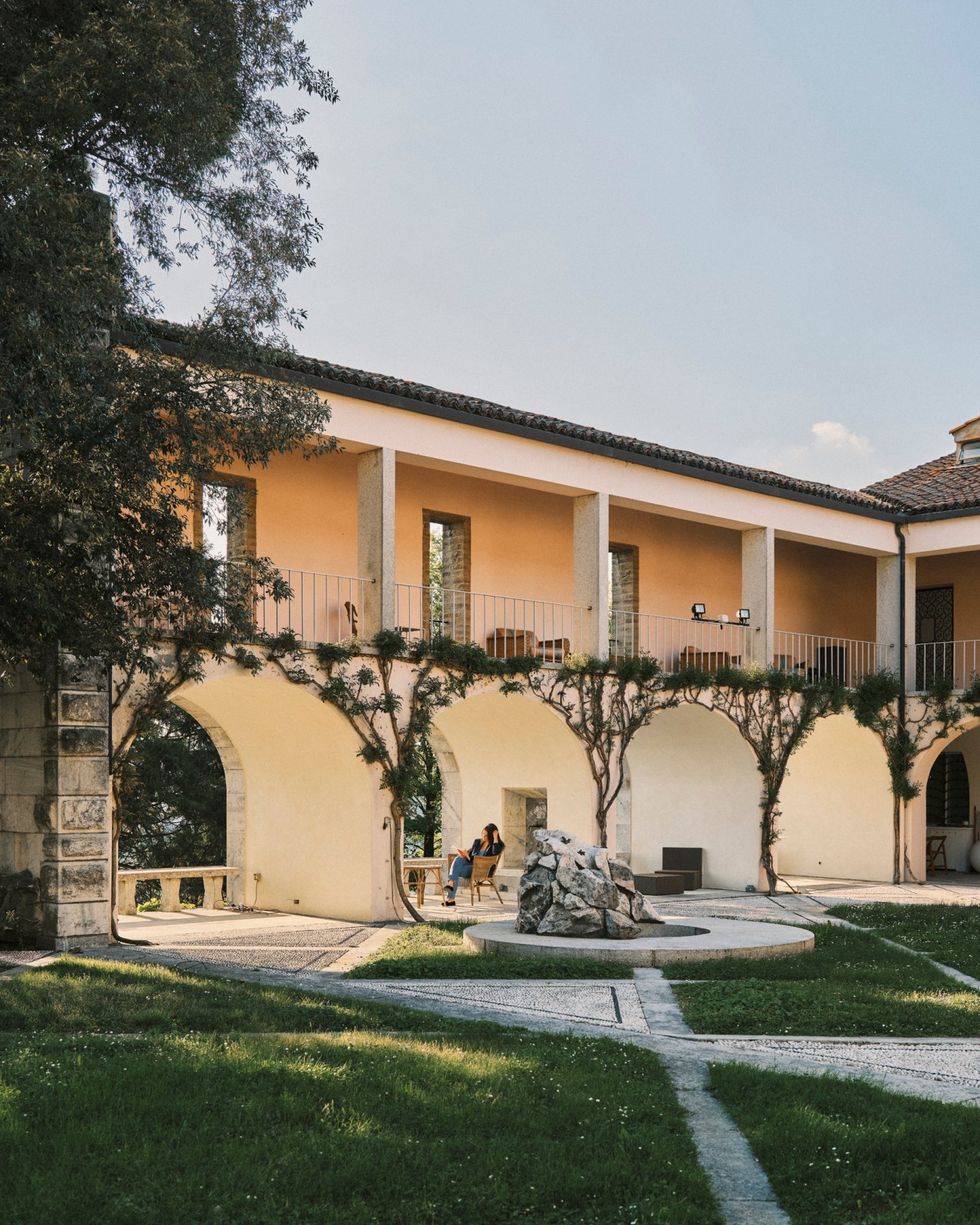 Curved terrace overlooking vineyards and valley at Villa Ottolenghi showcasing integration of landscape architecture