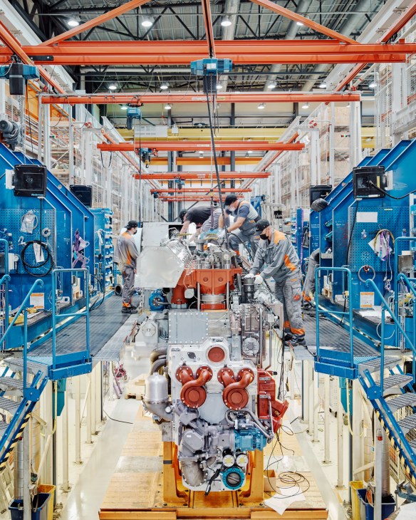Workers assembling engine components on an assembly line at the Wärtsilä factory in Vaasa, Finland.