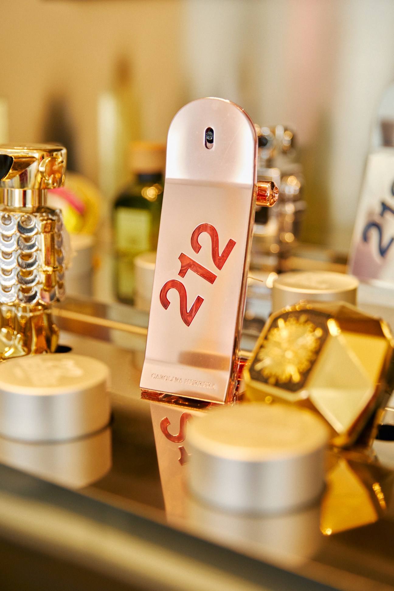 A collection of various Puig-owned fragrance bottles arranged together