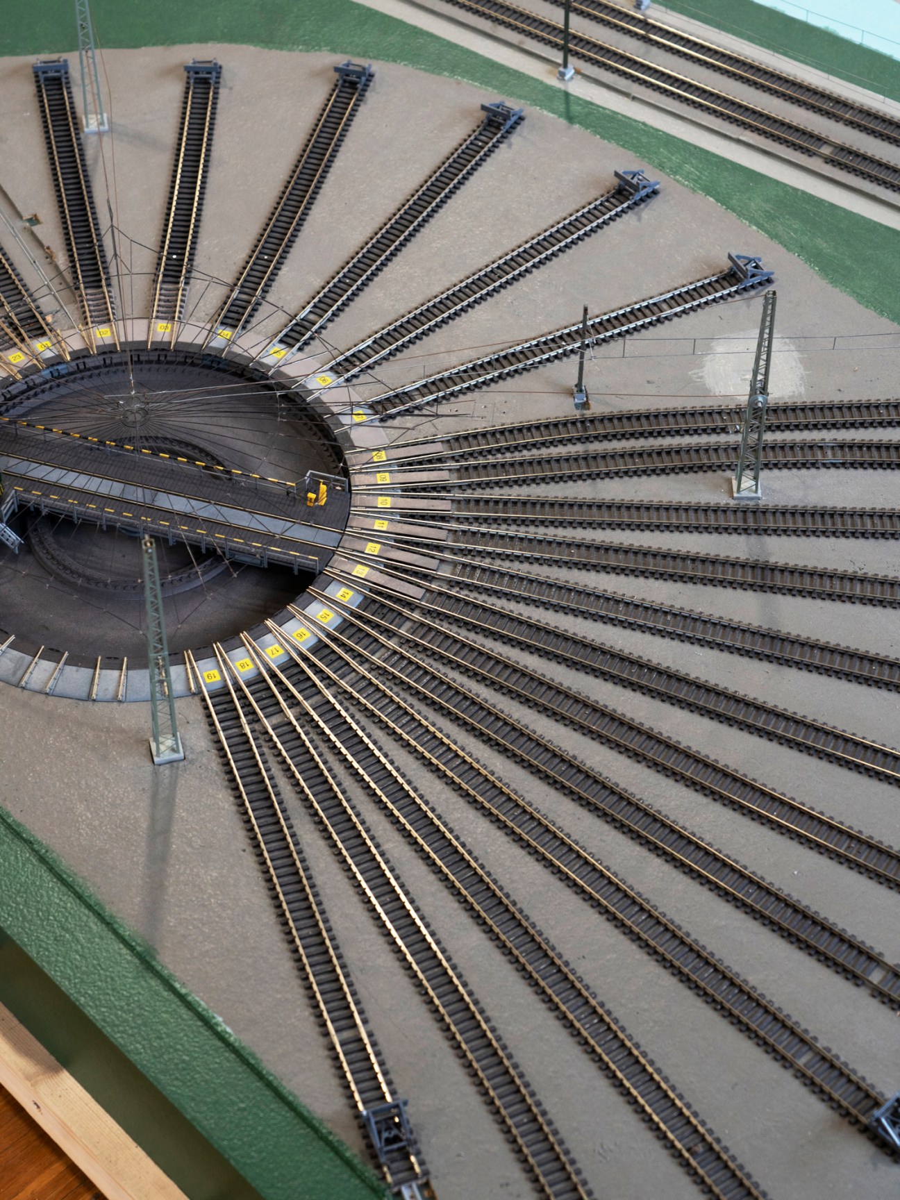 Model railway turntable with multiple radiating tracks and switching points in laboratory setting