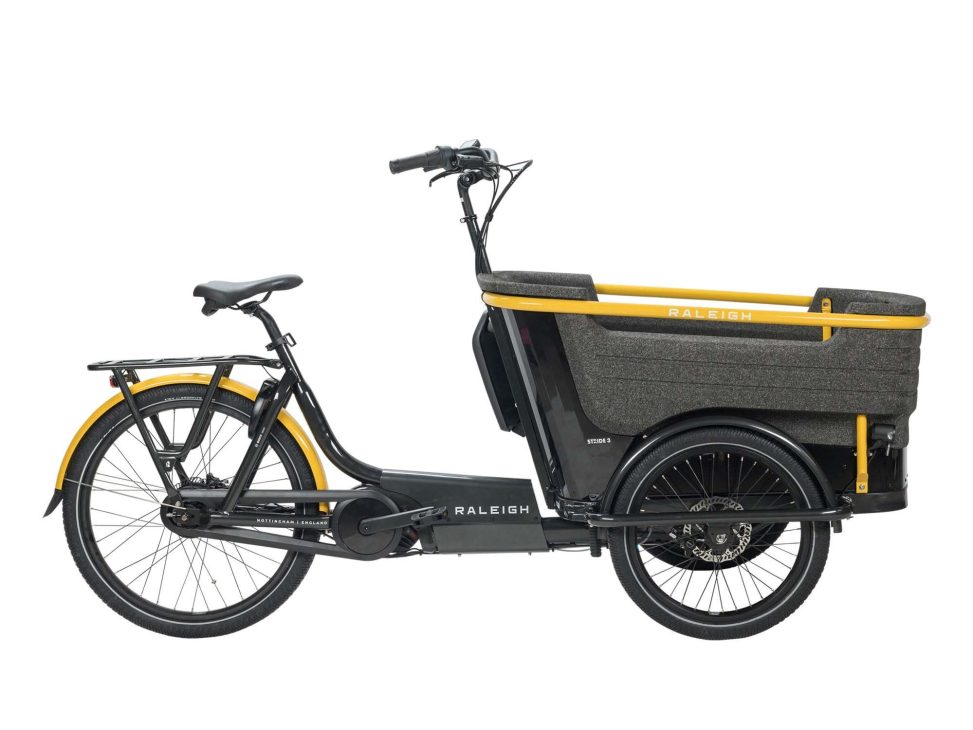 Raleigh Stride electric cargo bike with large front carrier box in black and yellow colorway