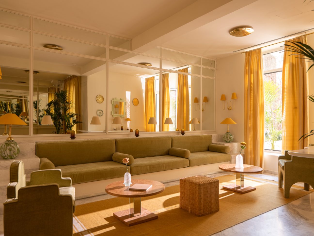 Lounge area with brown couches, wooden floors and side table.