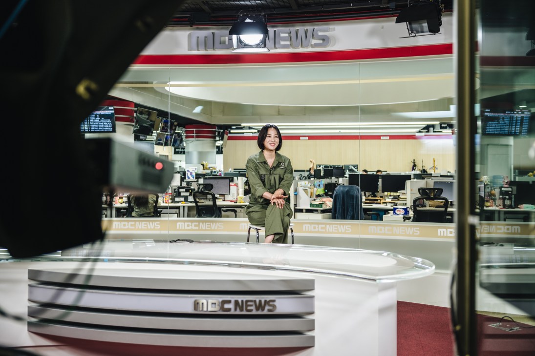 Kang Da-som, an announcer for South Korea's MBC network, recording a news item in a broadcast studio.