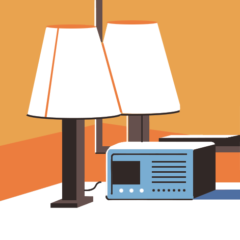 Table lamp and vintage radio on surface against orange background