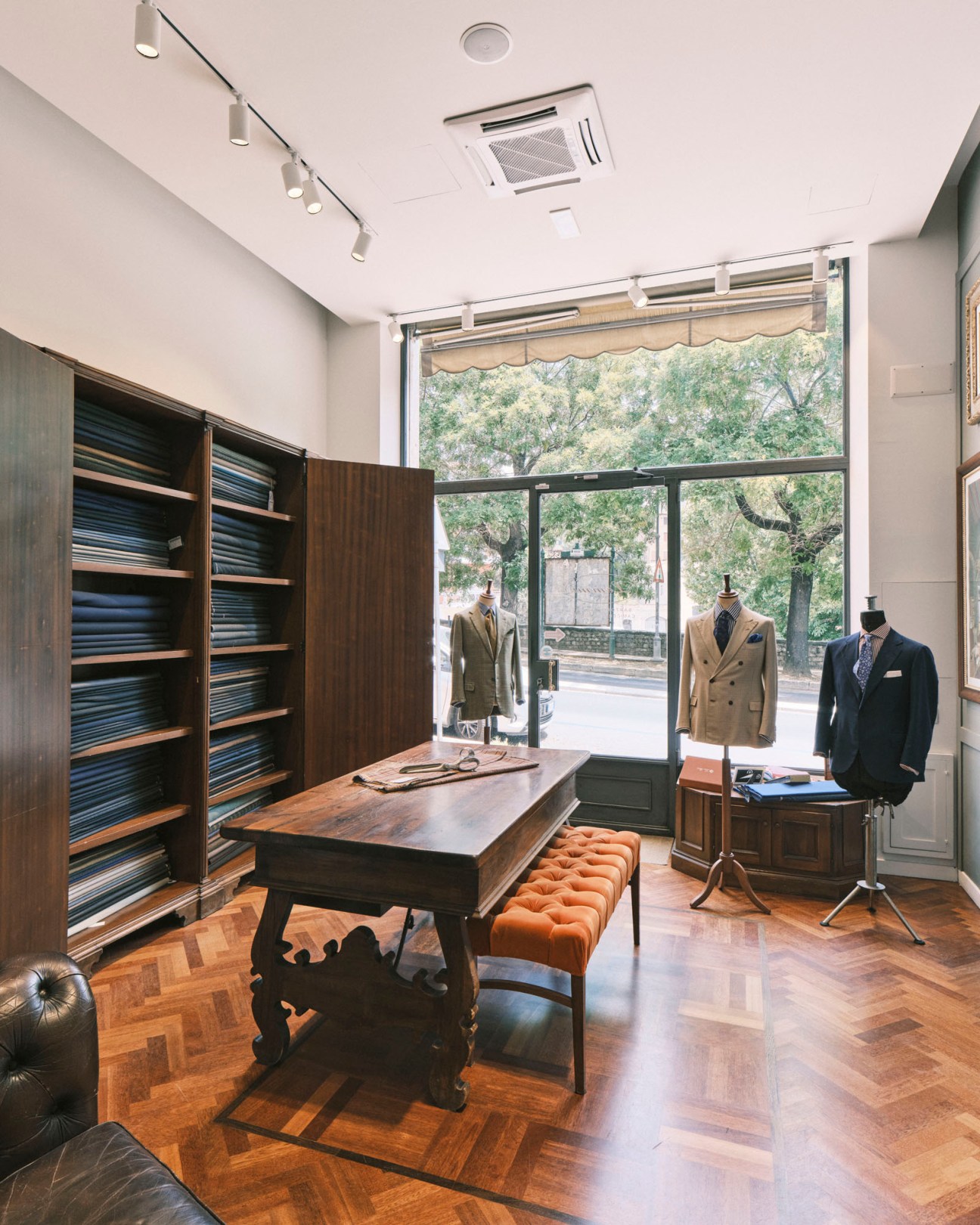 Interior of Sartoria Lemmi's elegant Perugia workshop with traditional tailoring tools and fabrics