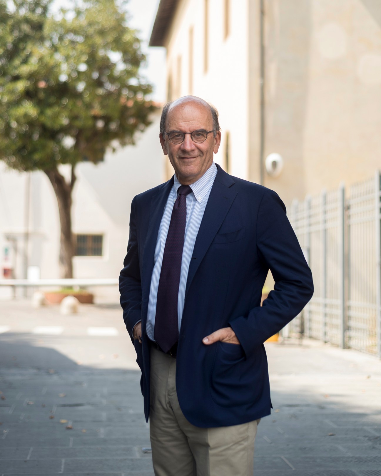 Raffaello Napoleone, CEO of Pitti Immagine, standing outdoors in a navy blazer and striped shirt.
