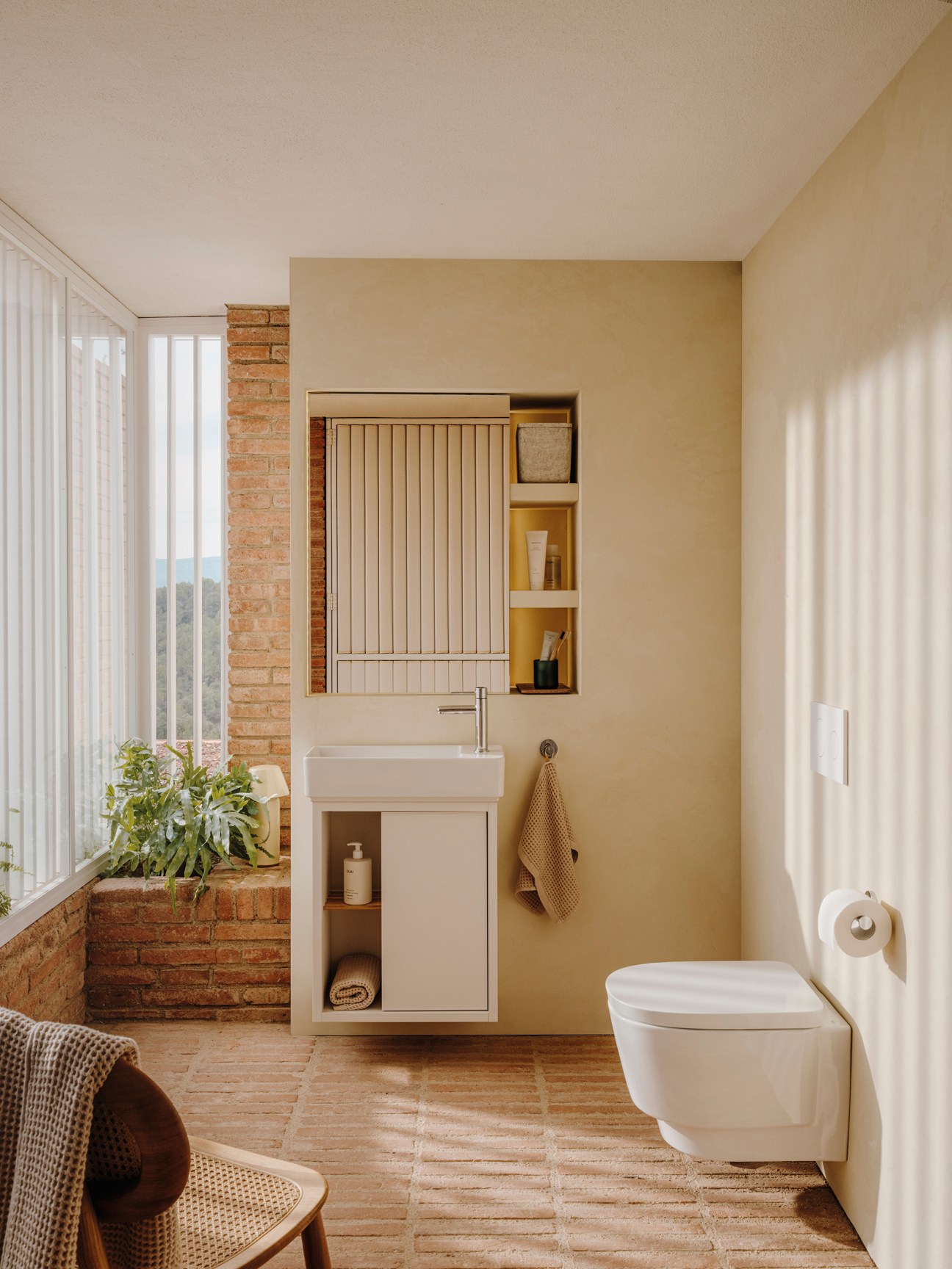 Modern bathroom interior with floating vanity, mirror cabinet, wall-mounted toilet and warm wood-toned finishes