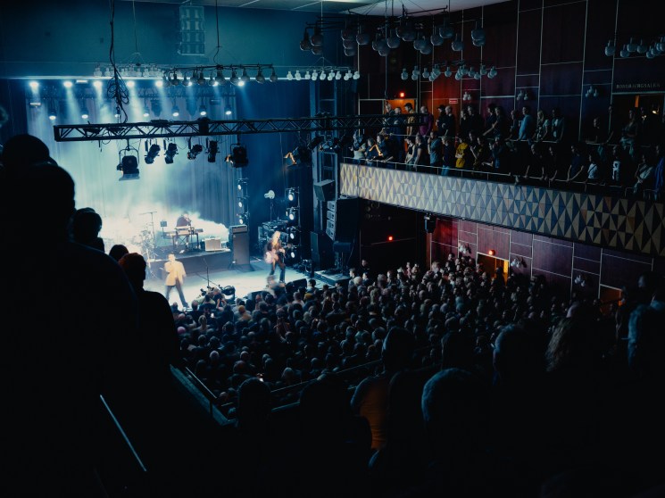 Interior view of Vega concert hall during performance showing packed audience, multi-level seating, and stage lighting