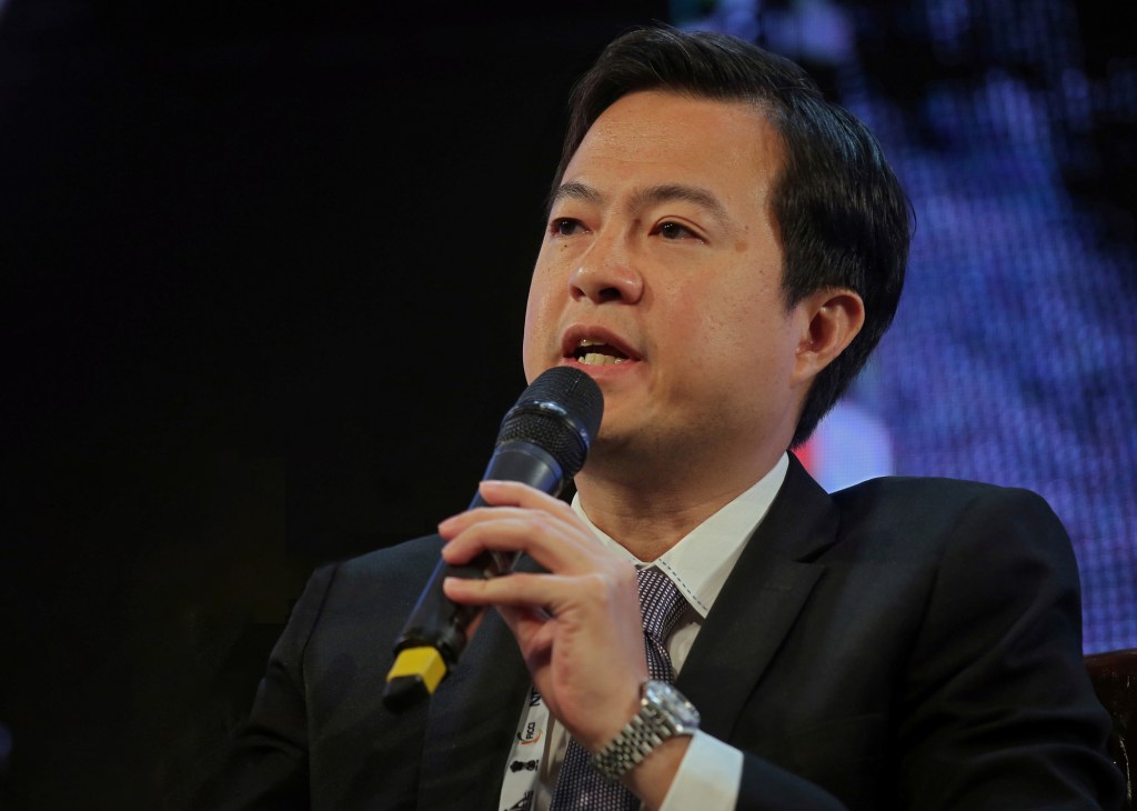 Leslie Thng, CEO of Scoot airline, speaking at a microphone during a presentation.