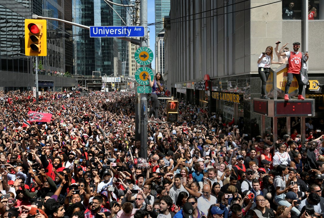 Massive crowd fills Toronto streets during Toronto Raptors NBA championship victory parade on University Avenue.