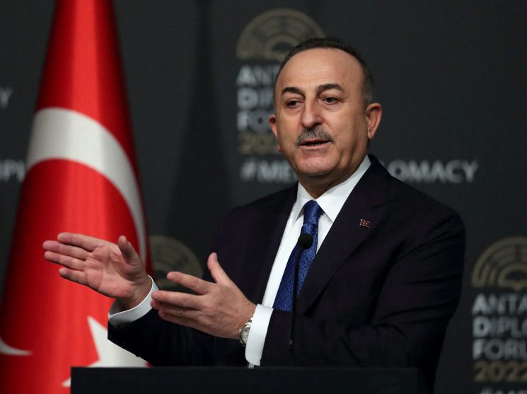 Turkish Foreign Minister Mevlut Cavusoglu speaking with hand gestures at the Antalya Diplomacy Forum