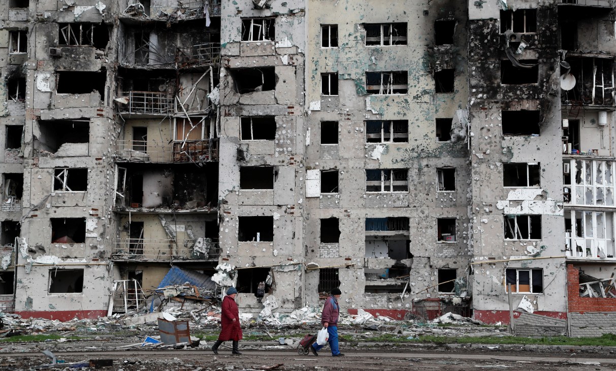 Multi-storey residential building in Mariupol with severe structural damage, broken windows and damaged balconies