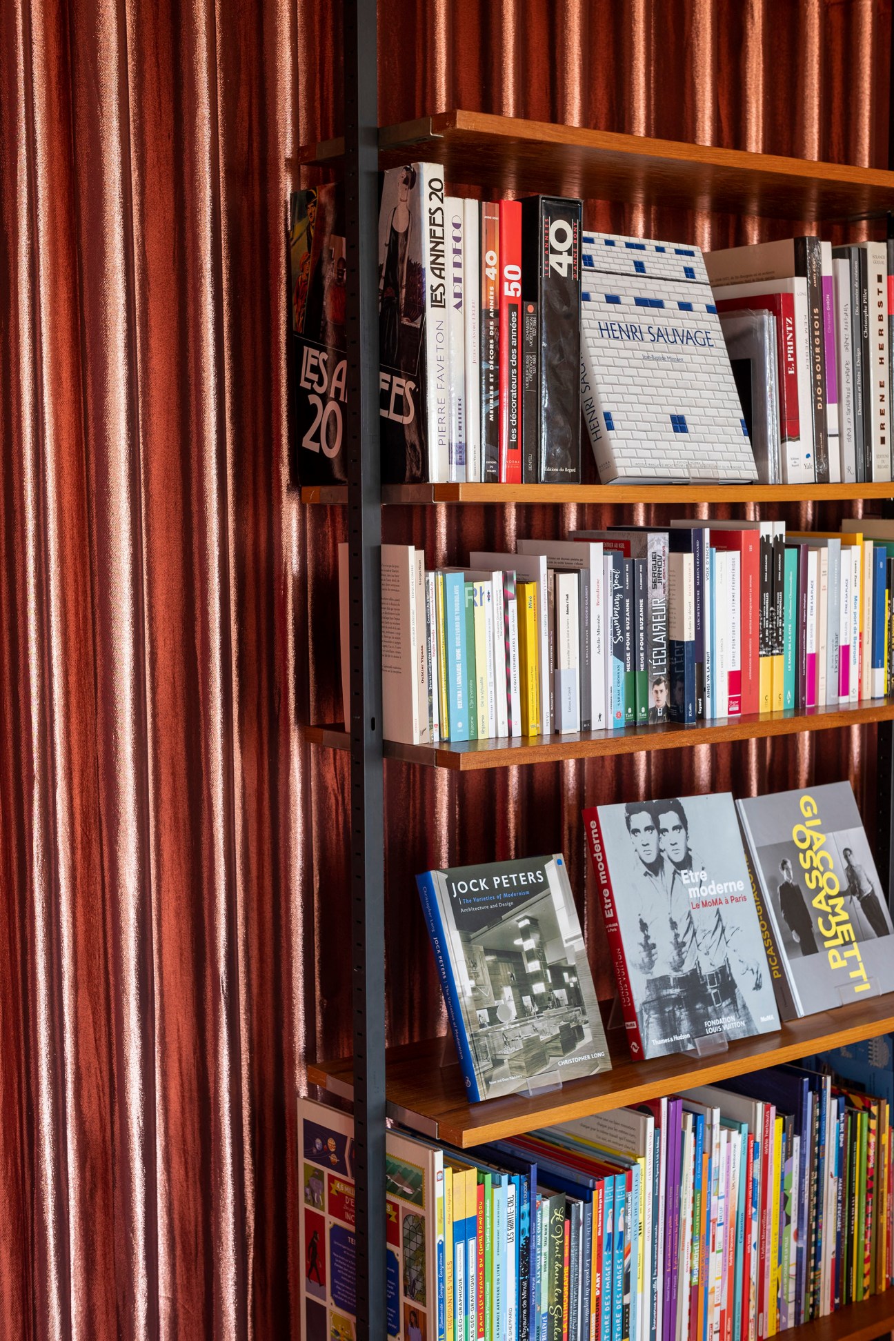 Wooden shelves filled with books and magazines at Rupture-Imbernon bookstore
