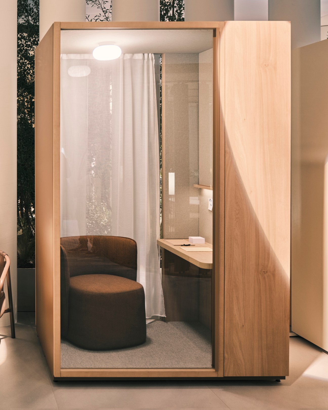 Kall M telephone booth by Kettal with adjustable desk and overhead lighting